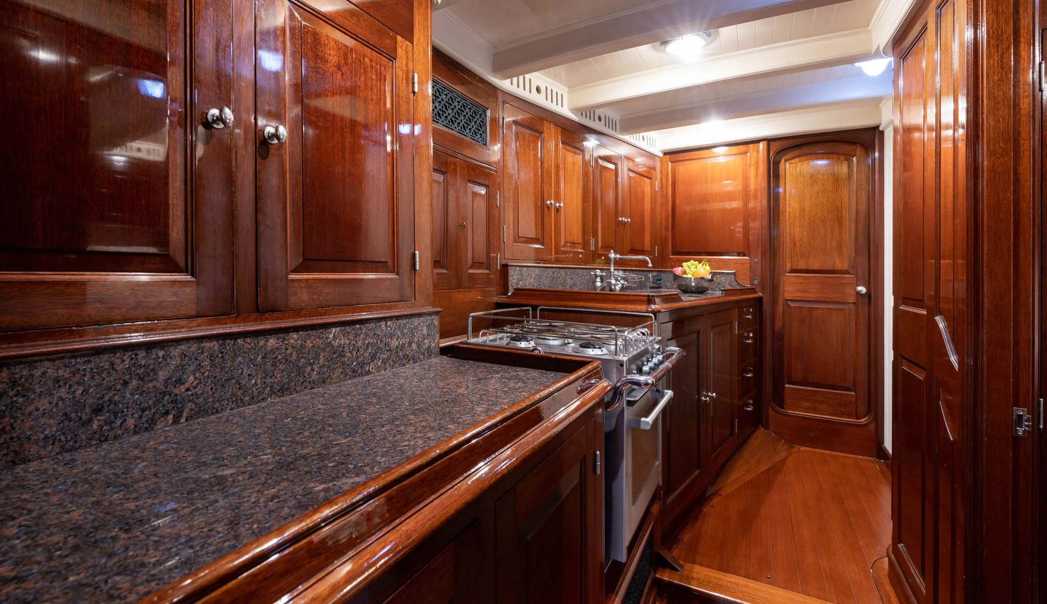 a kitchen with wooden cabinets aboard SAVANNAH Yacht for Sale