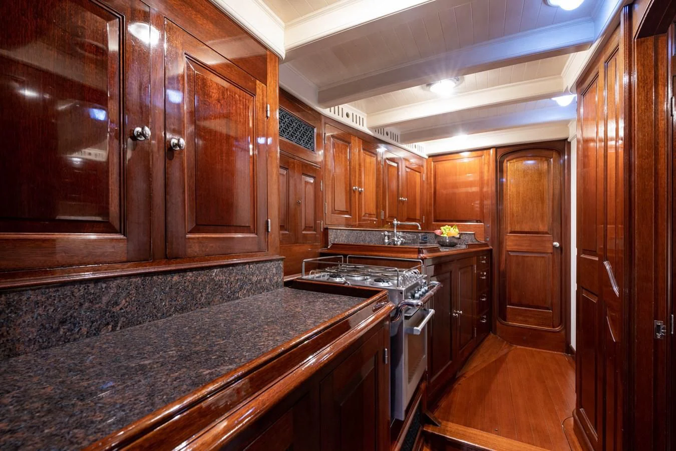 a kitchen with wooden cabinets aboard SAVANNAH Yacht for Sale