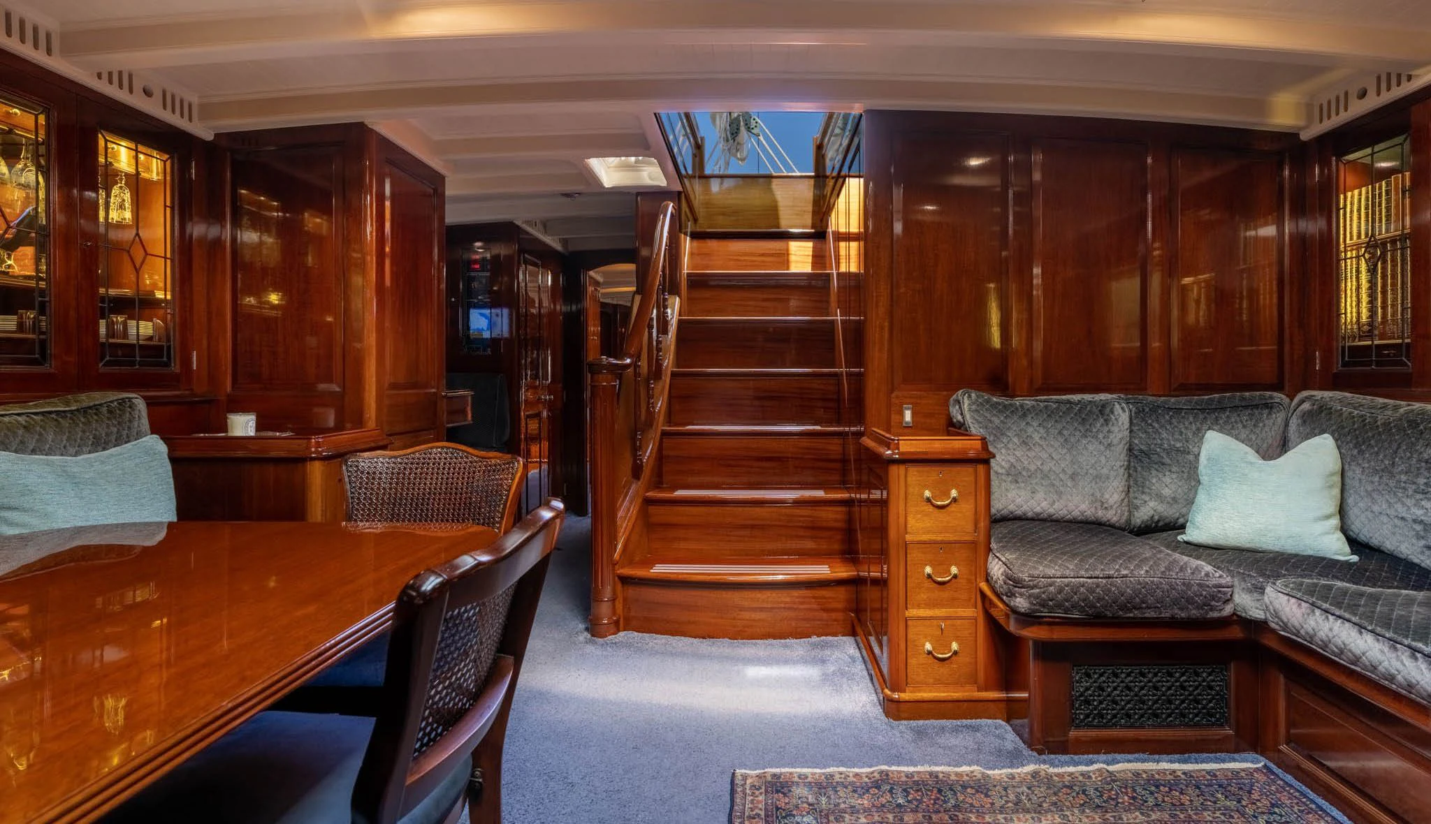 a living room with a staircase aboard SAVANNAH Yacht for Sale