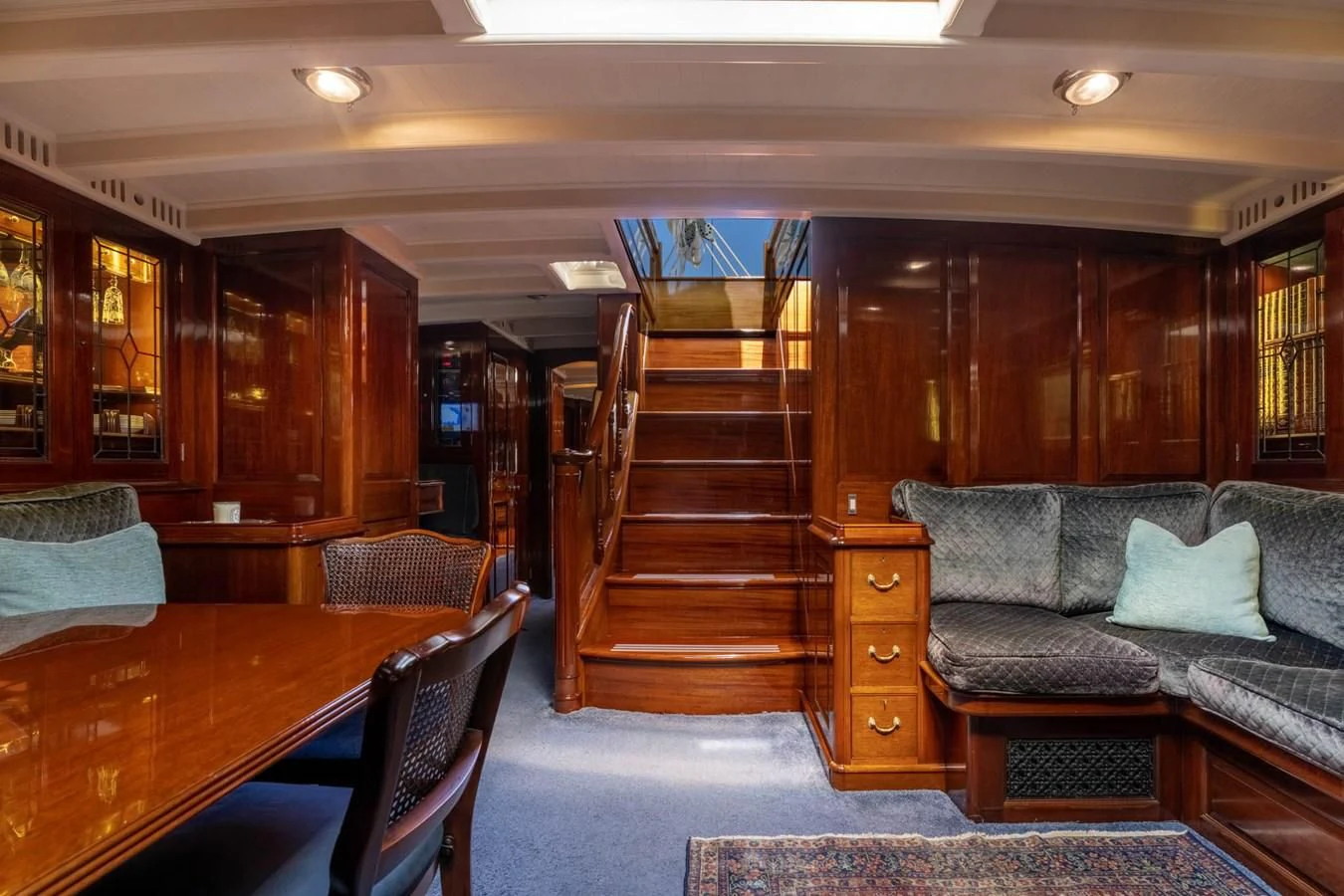 a living room with a staircase aboard SAVANNAH Yacht for Sale