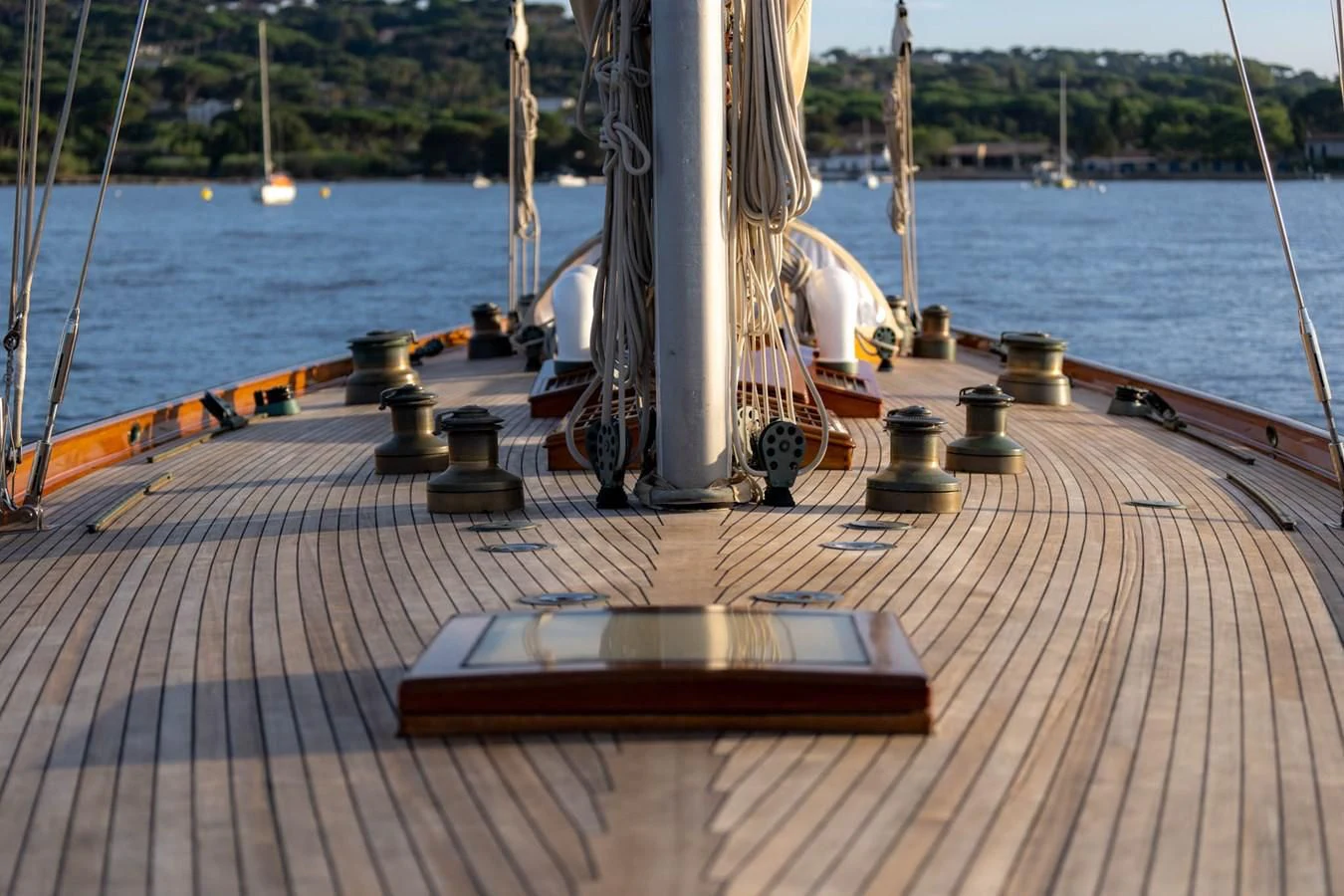 a wood deck with a railing and a body of water in the background aboard SAVANNAH Yacht for Sale