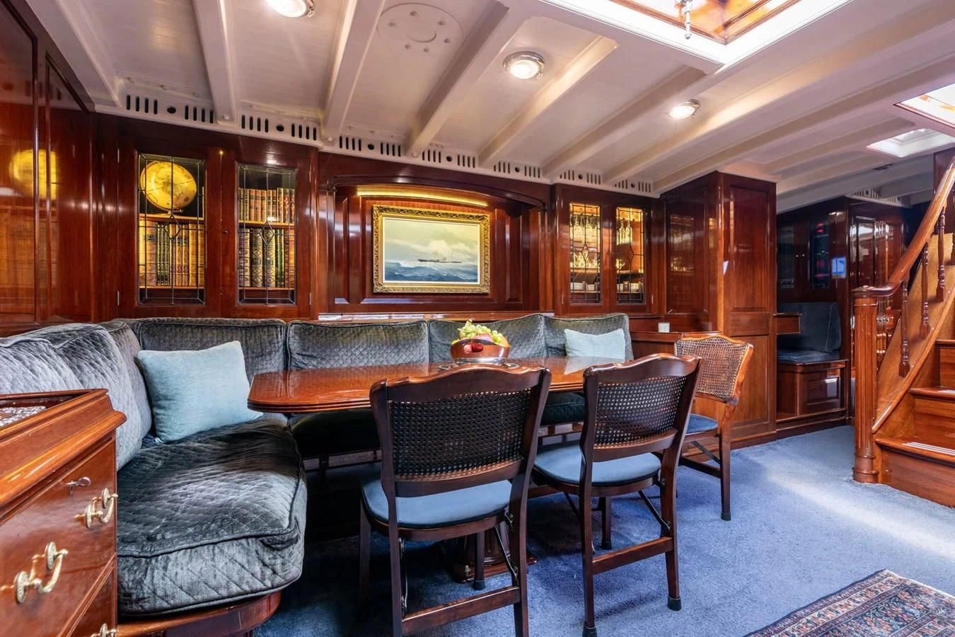 a living room with a leather couch and a wood table aboard SAVANNAH Yacht for Sale
