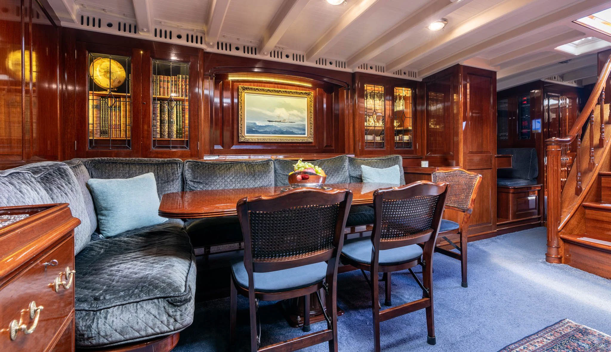 a living room with a leather couch and a table aboard SAVANNAH Yacht for Sale