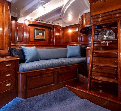 a couch in a cabin aboard SAVANNAH Yacht for Sale