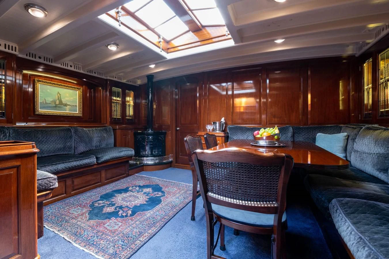 a living room with leather couches and a table aboard SAVANNAH Yacht for Sale