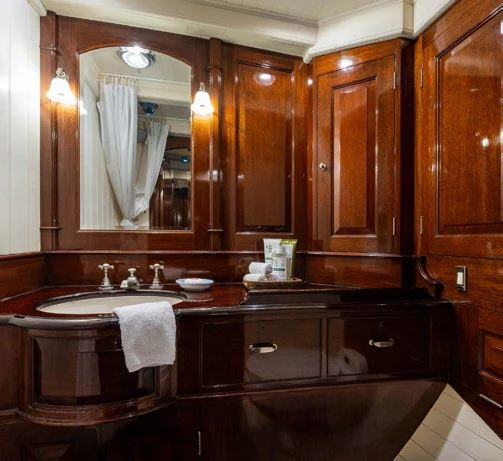 a bathroom with wooden cabinets aboard SAVANNAH Yacht for Sale