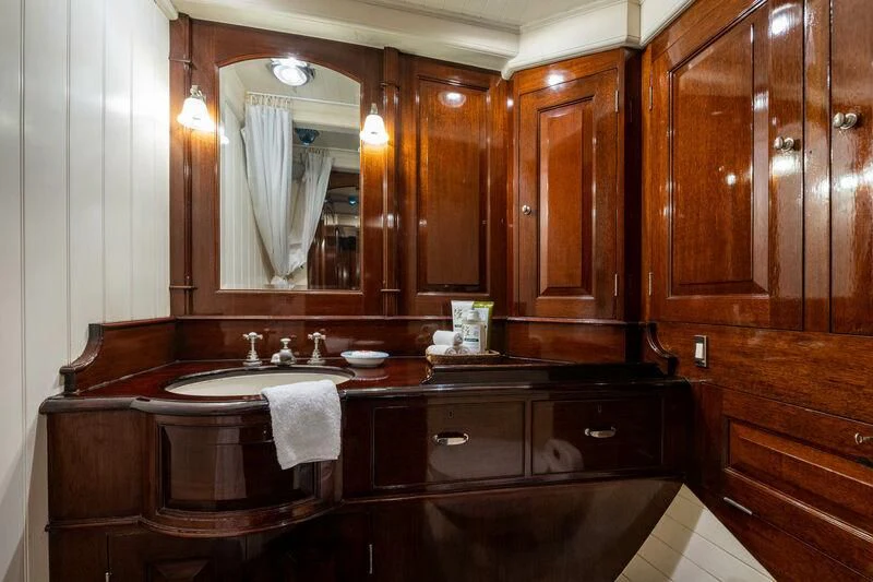 a bathroom with wooden cabinets aboard SAVANNAH Yacht for Sale