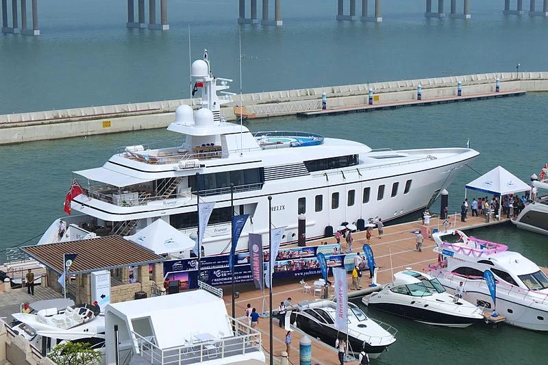 a large white boat docked at a pier aboard MEGAN Yacht for Sale