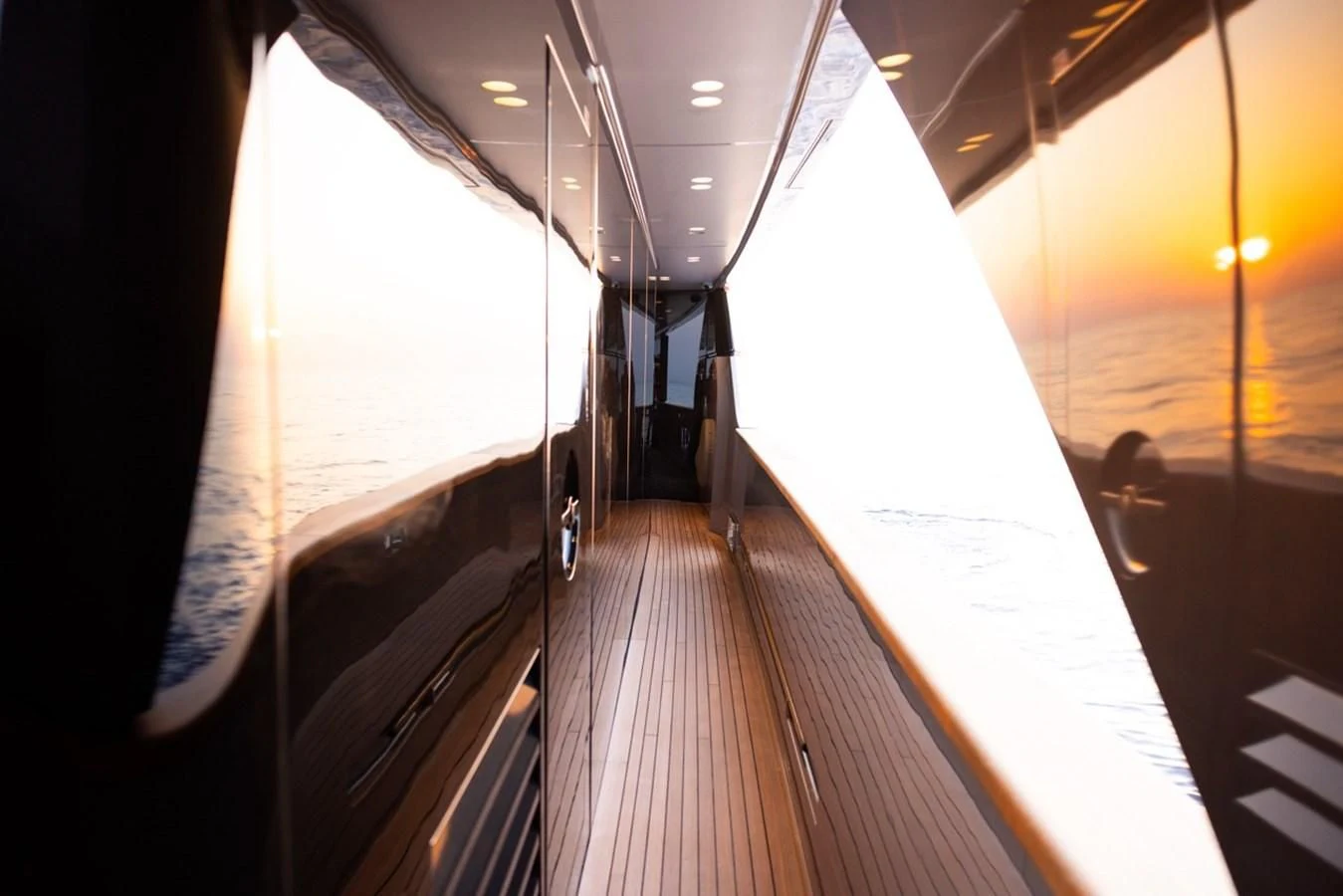 a person walking down a long wooden walkway aboard AMIGA Yacht for Sale