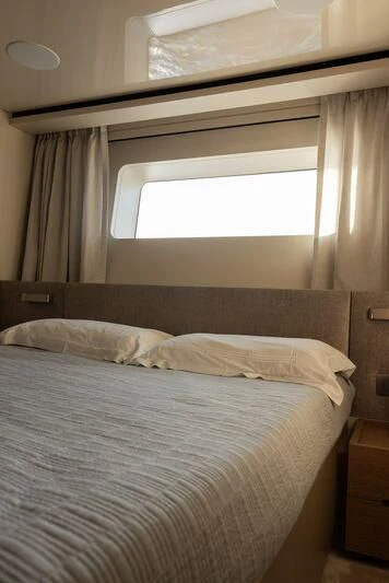 a bed with a white comforter aboard AMIGA Yacht for Sale