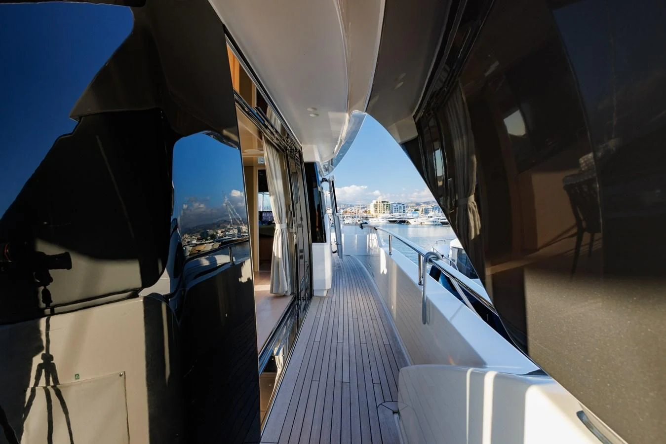 a hallway with a view of a city and water aboard AMIGA Yacht for Sale