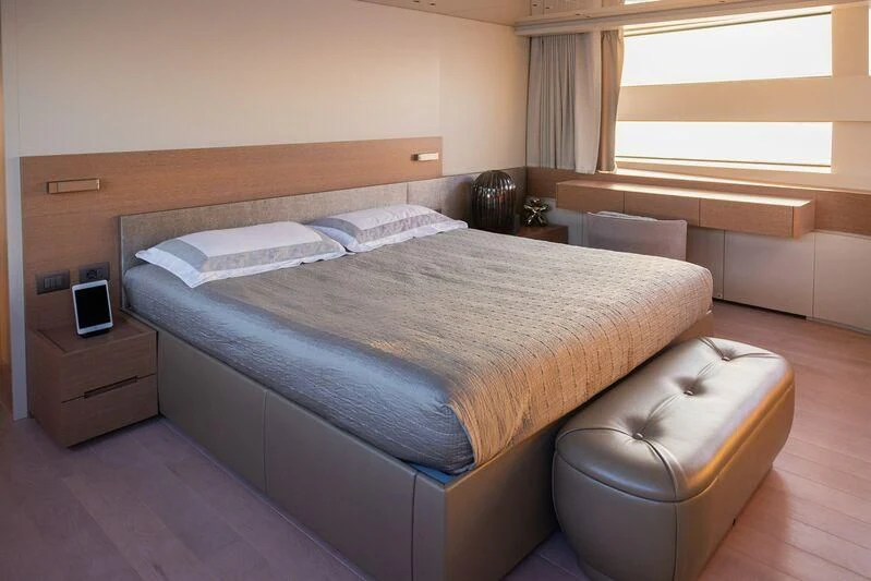 a bed with a white bed aboard AMIGA Yacht for Sale