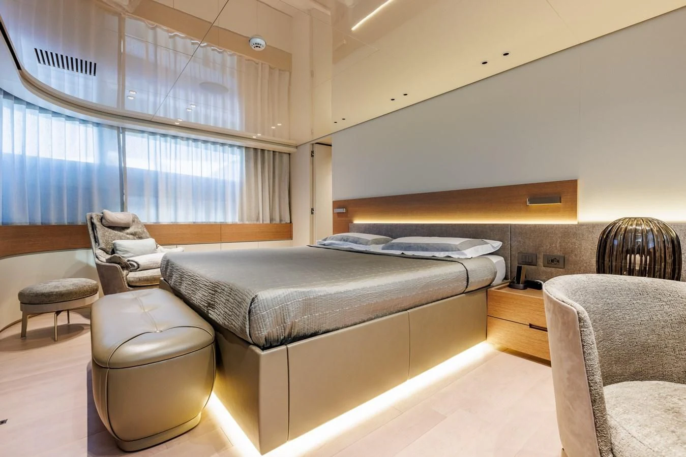 a bedroom with a bed and a couch aboard AMIGA Yacht for Sale