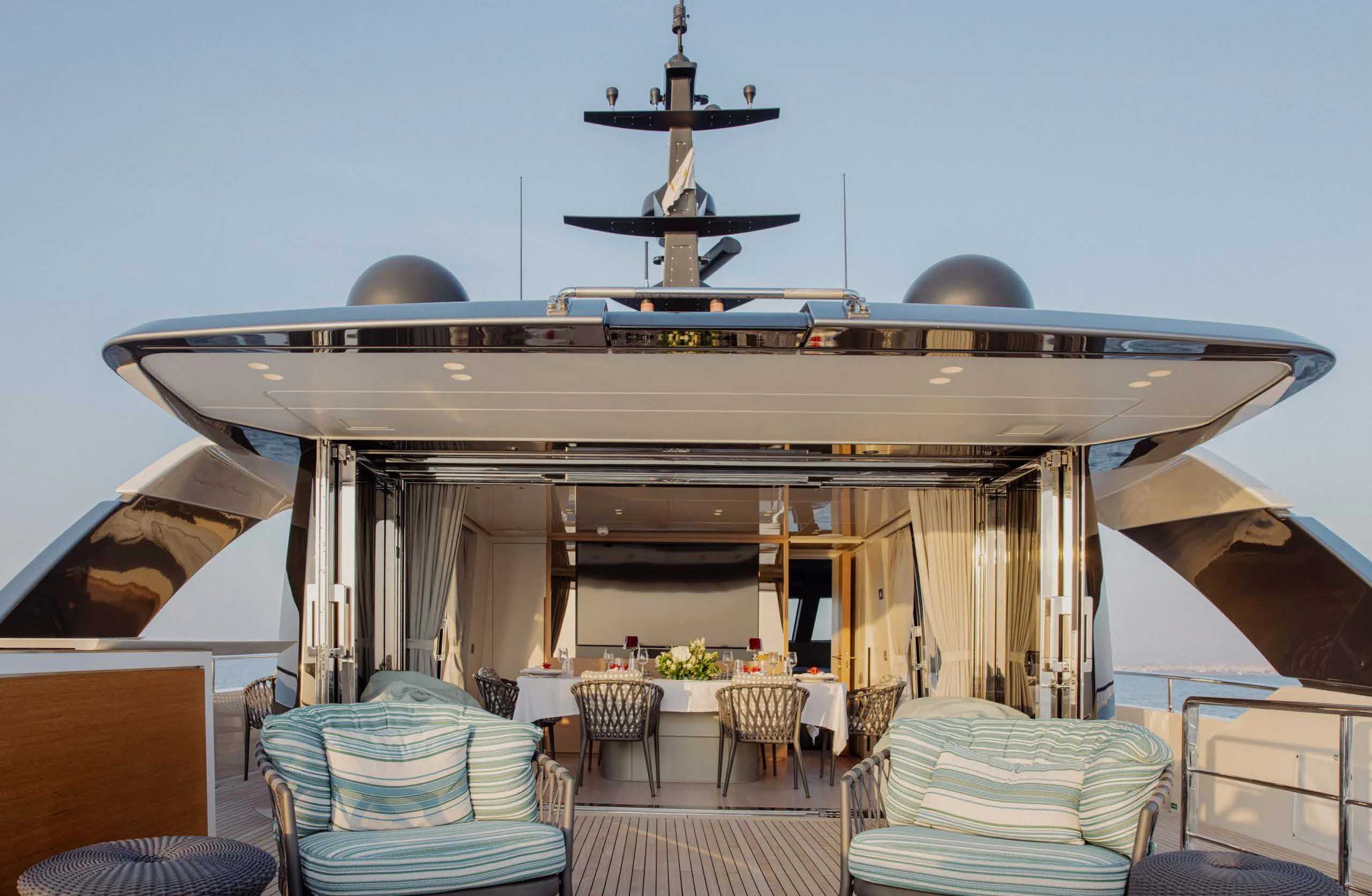 a large room with a table and chairs and a large ceiling fan aboard AMIGA Yacht for Sale
