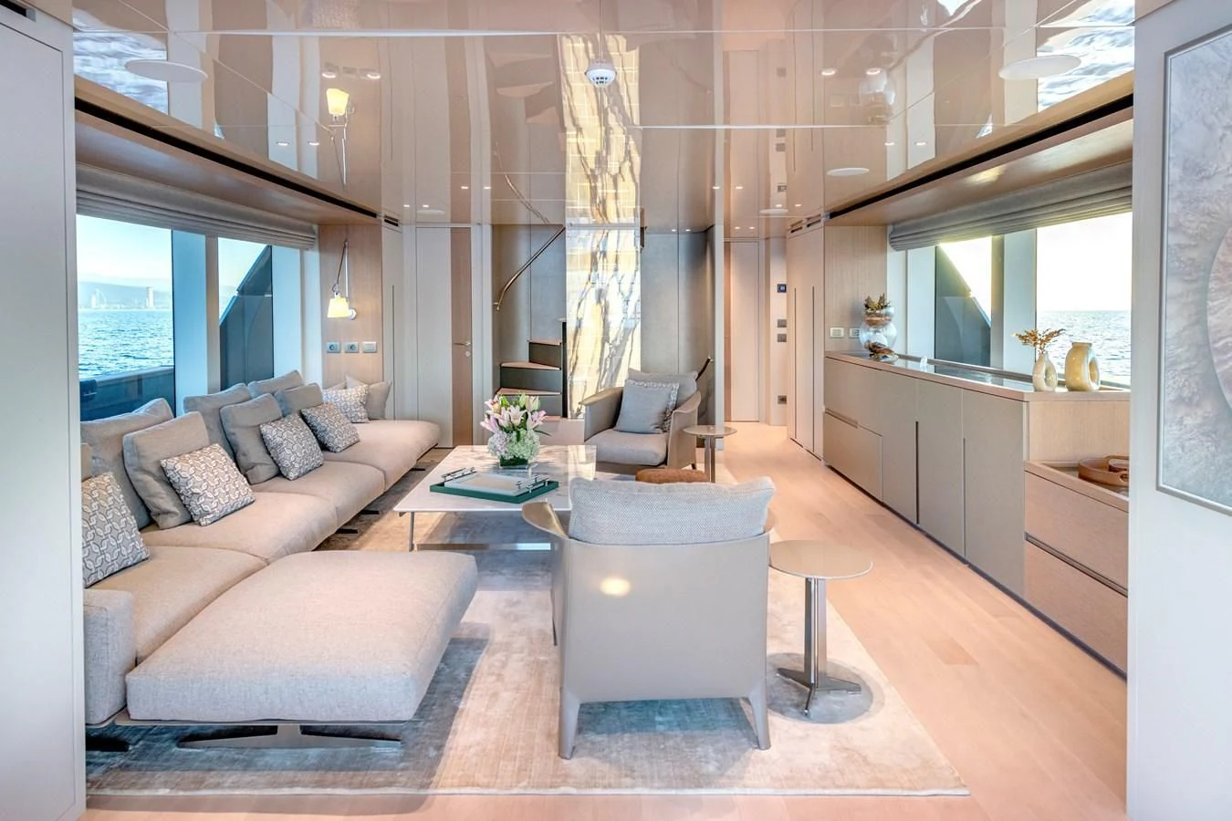 a living room with a couch and a table aboard AMIGA Yacht for Sale