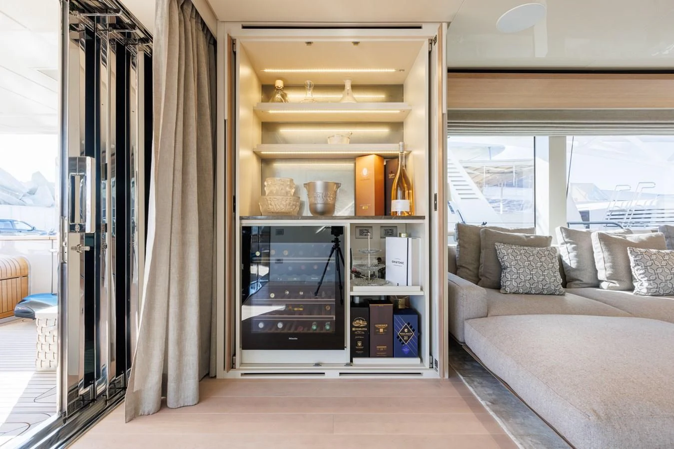 a room with a bed and a shelf with books on it aboard AMIGA Yacht for Sale