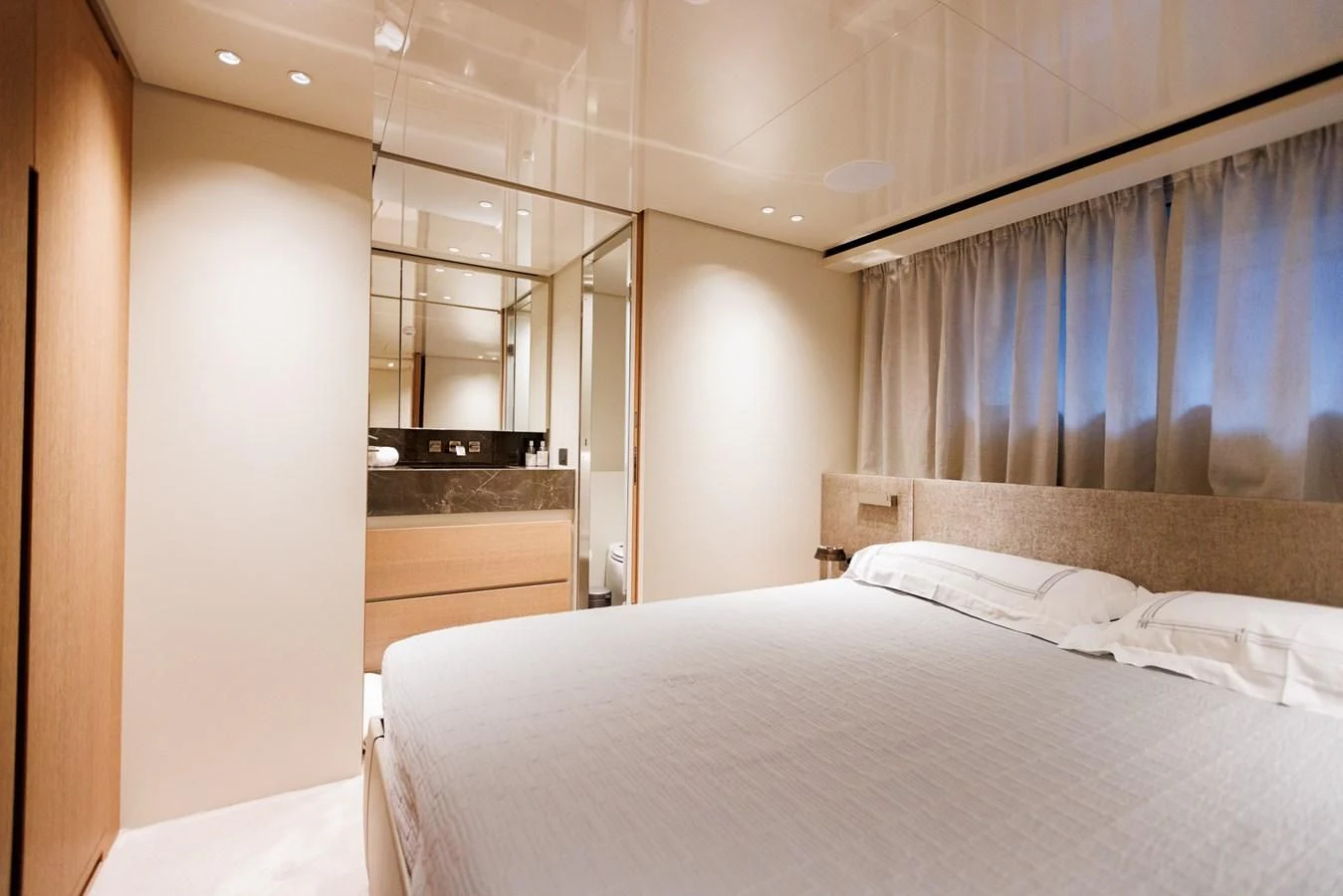 a bedroom with a bed and a window aboard AMIGA Yacht for Sale