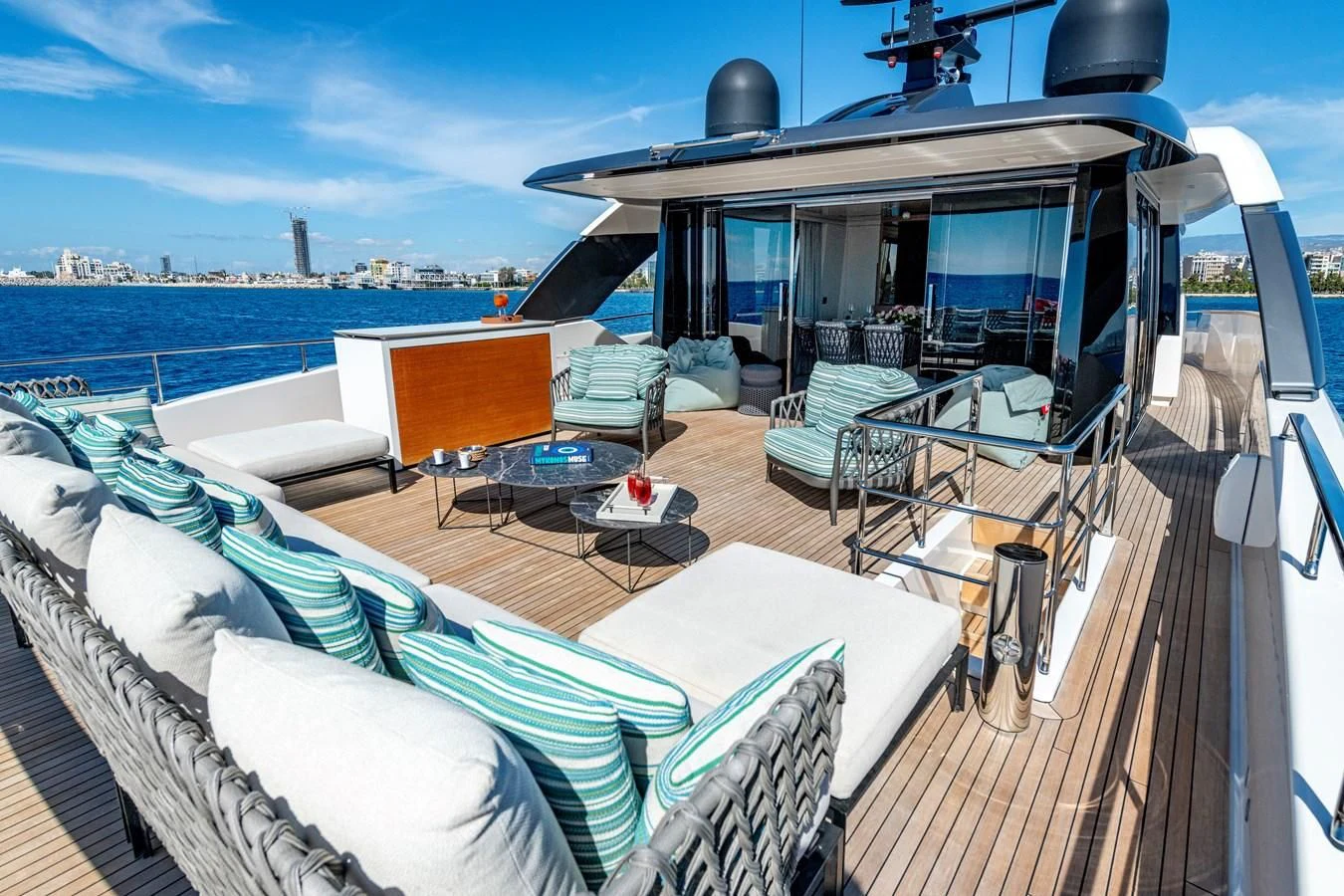 a deck with a view of the ocean and a city aboard AMIGA Yacht for Sale