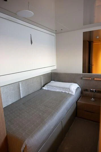 a bed with a white comforter aboard AMIGA Yacht for Sale