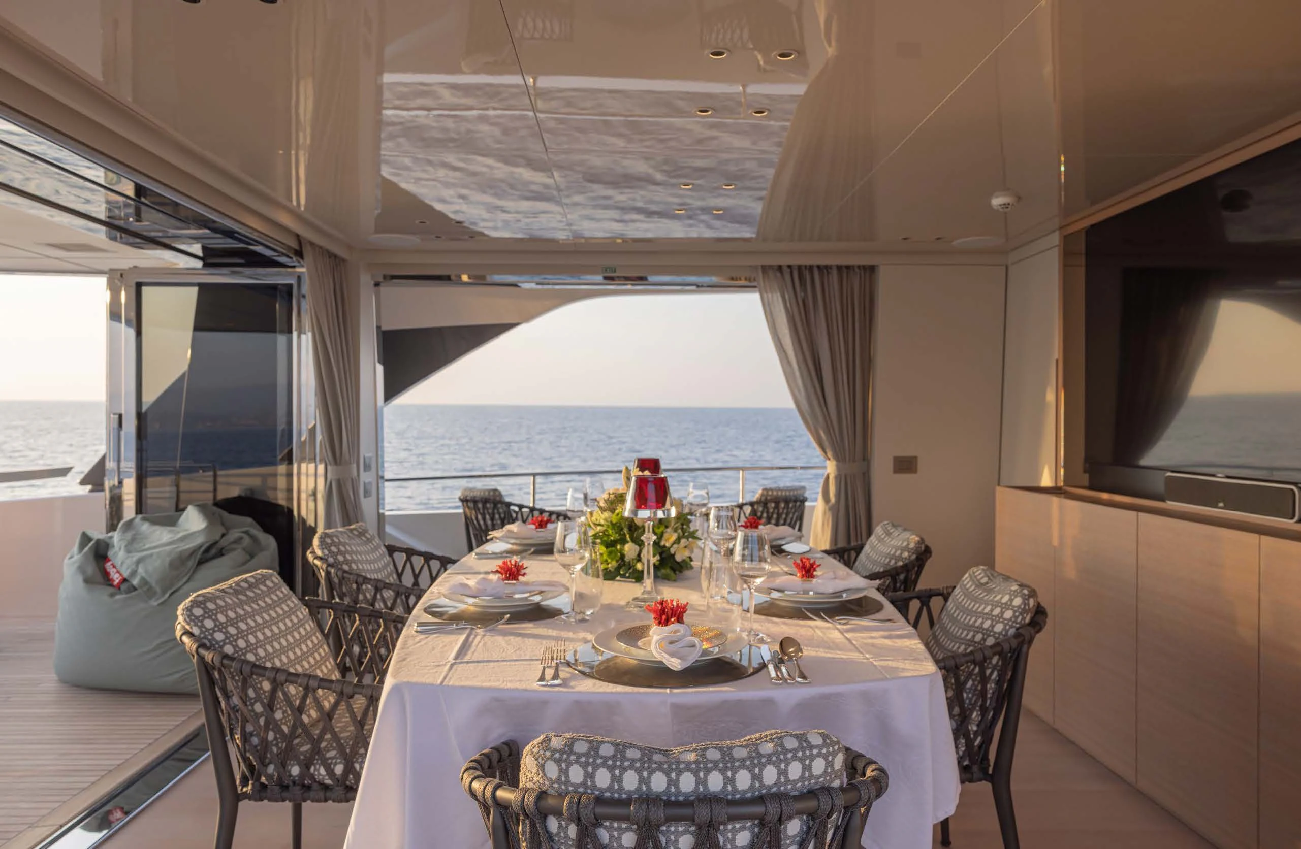 a dining table on a balcony aboard AMIGA Yacht for Sale