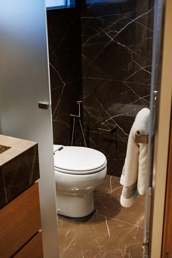 a toilet with a black wall aboard AMIGA Yacht for Sale