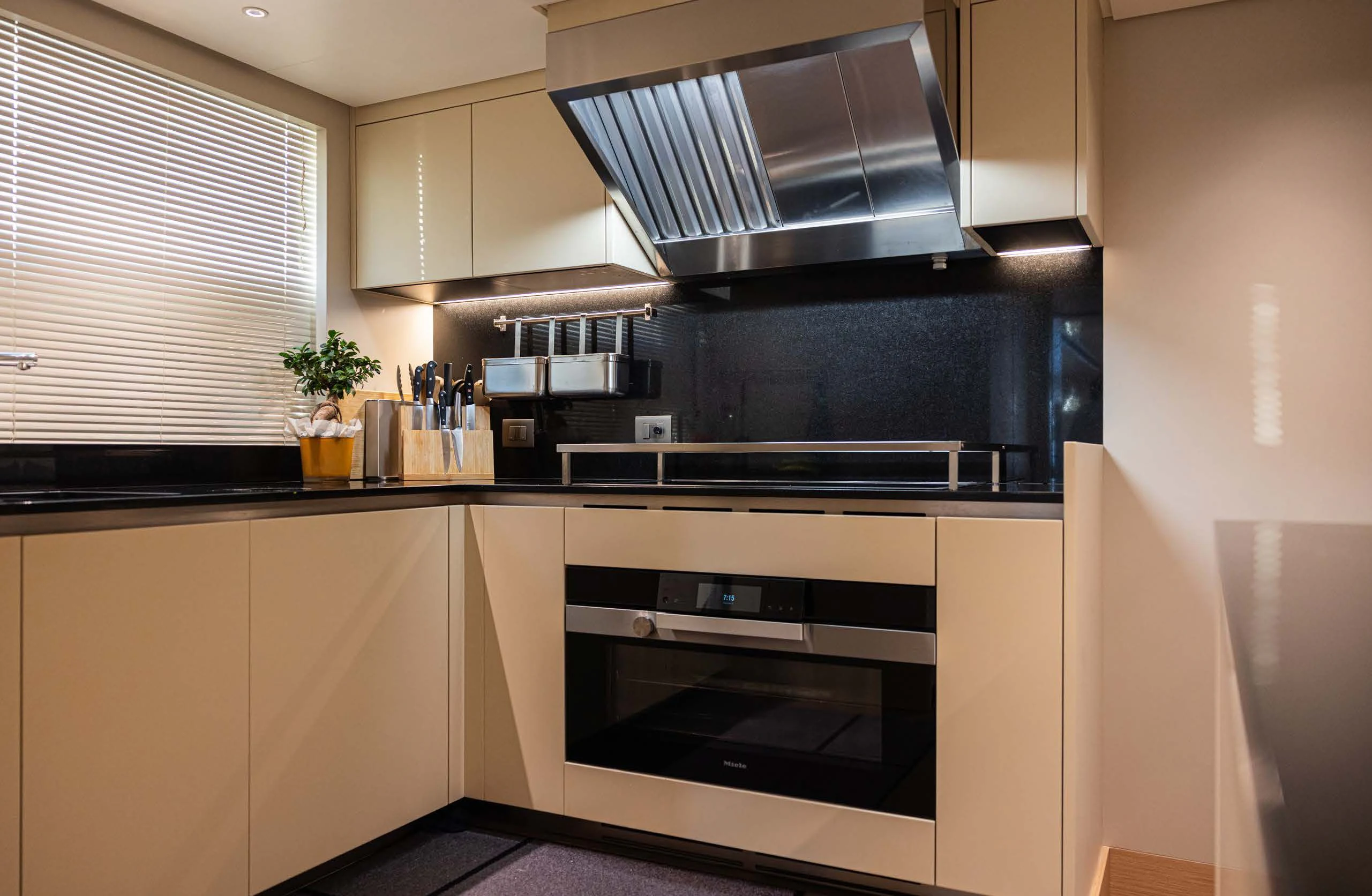 a kitchen with a stove and cabinets aboard AMIGA Yacht for Sale