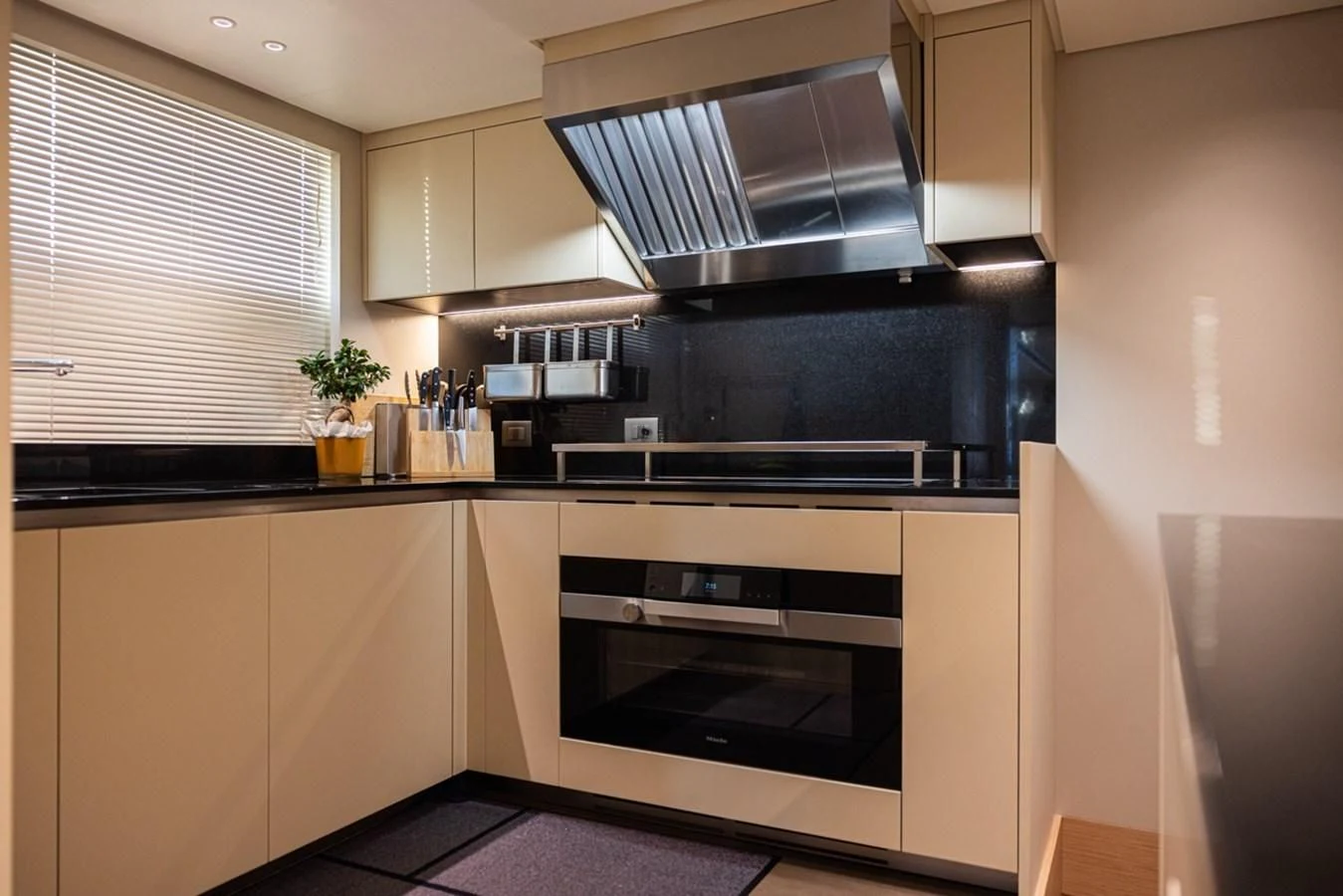 a kitchen with white cabinets aboard AMIGA Yacht for Sale