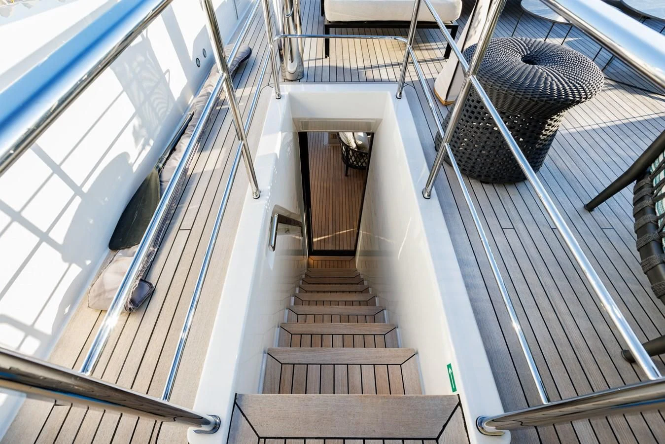 a staircase with a chair on the side aboard AMIGA Yacht for Sale