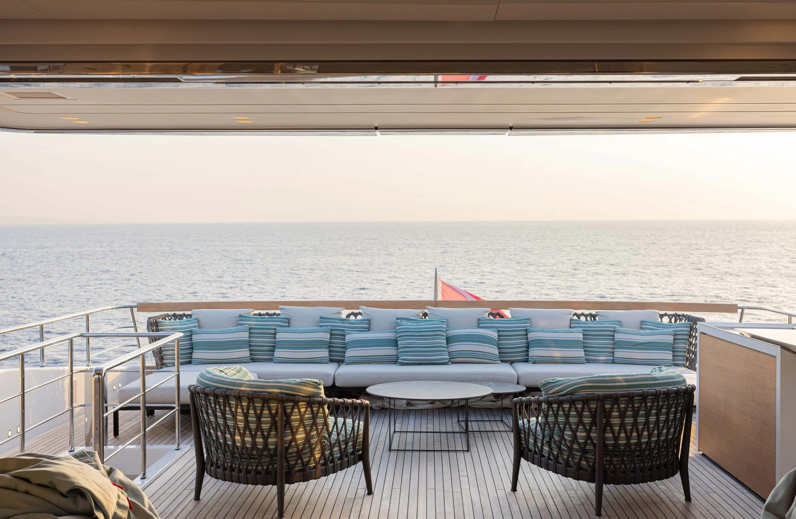 a table and chairs on a balcony aboard AMIGA Yacht for Sale