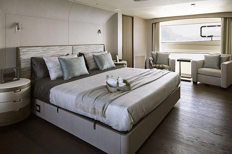 a bed with a white bed spread aboard ANURAG Yacht for Sale