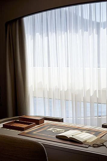 a window with blinds and a book on it aboard ANURAG Yacht for Sale