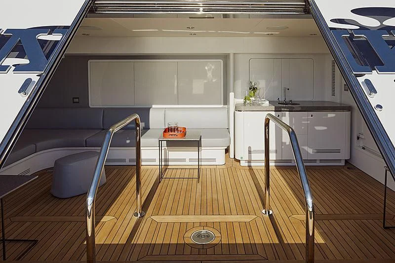 a room with a wood floor and a white desk and a blue wall aboard ANURAG Yacht for Sale