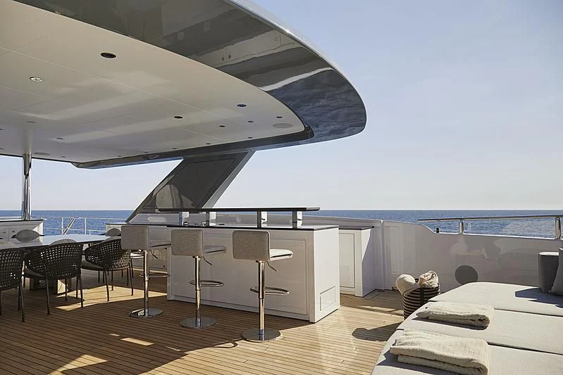 a room with a large balcony aboard ANURAG Yacht for Sale