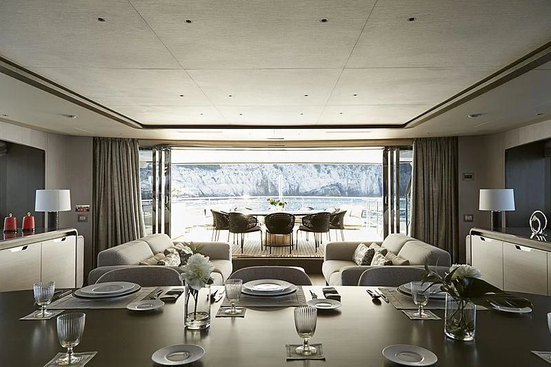 a large dining room with a large window aboard ANURAG Yacht for Sale