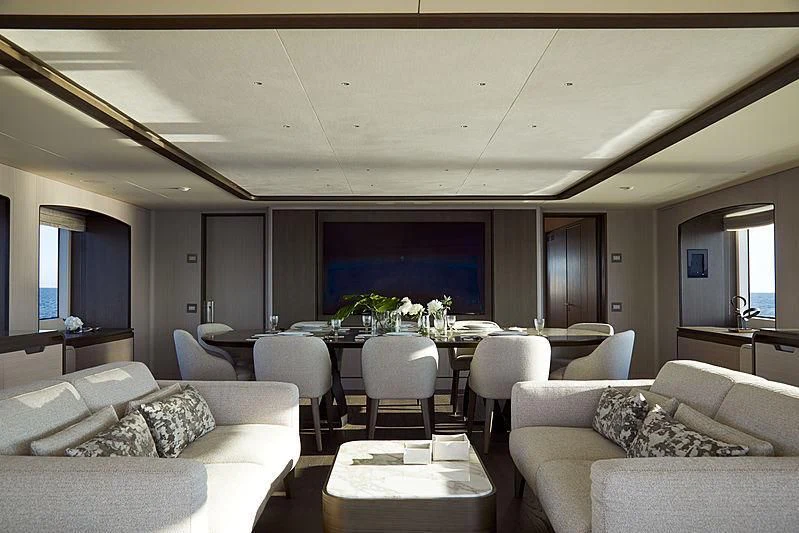 a living room with a large table and chairs aboard ANURAG Yacht for Sale