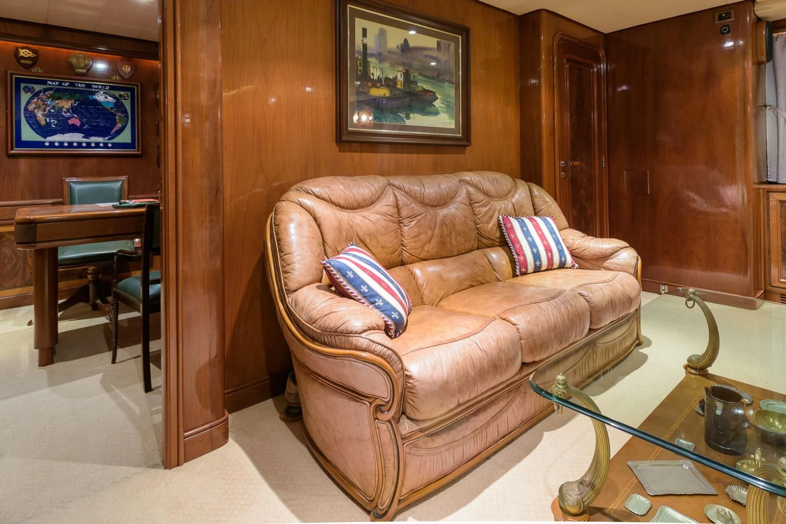 a brown leather couch in a living room aboard ELBA Yacht for Sale