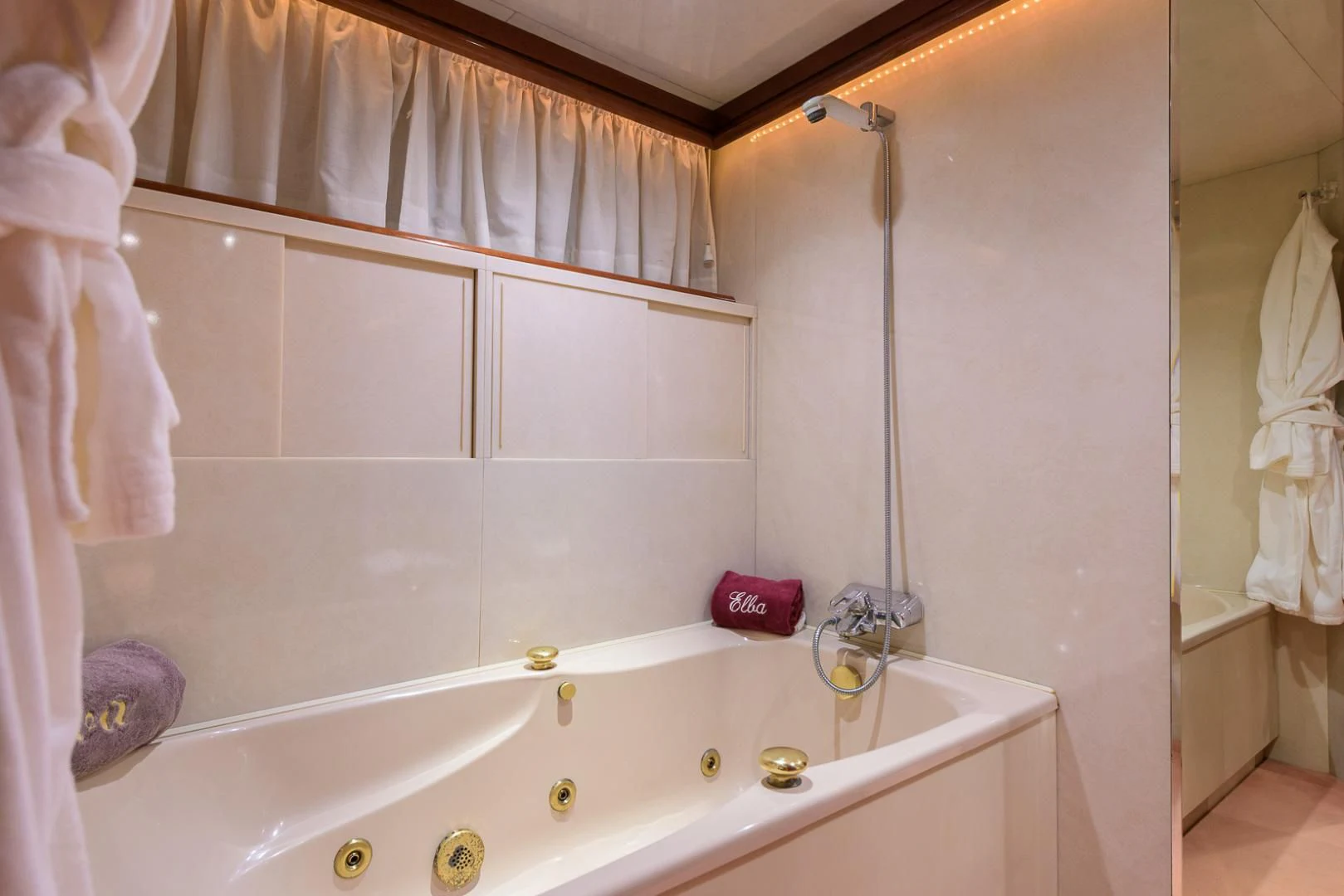 a bathroom with a bathtub and shower aboard ELBA Yacht for Sale