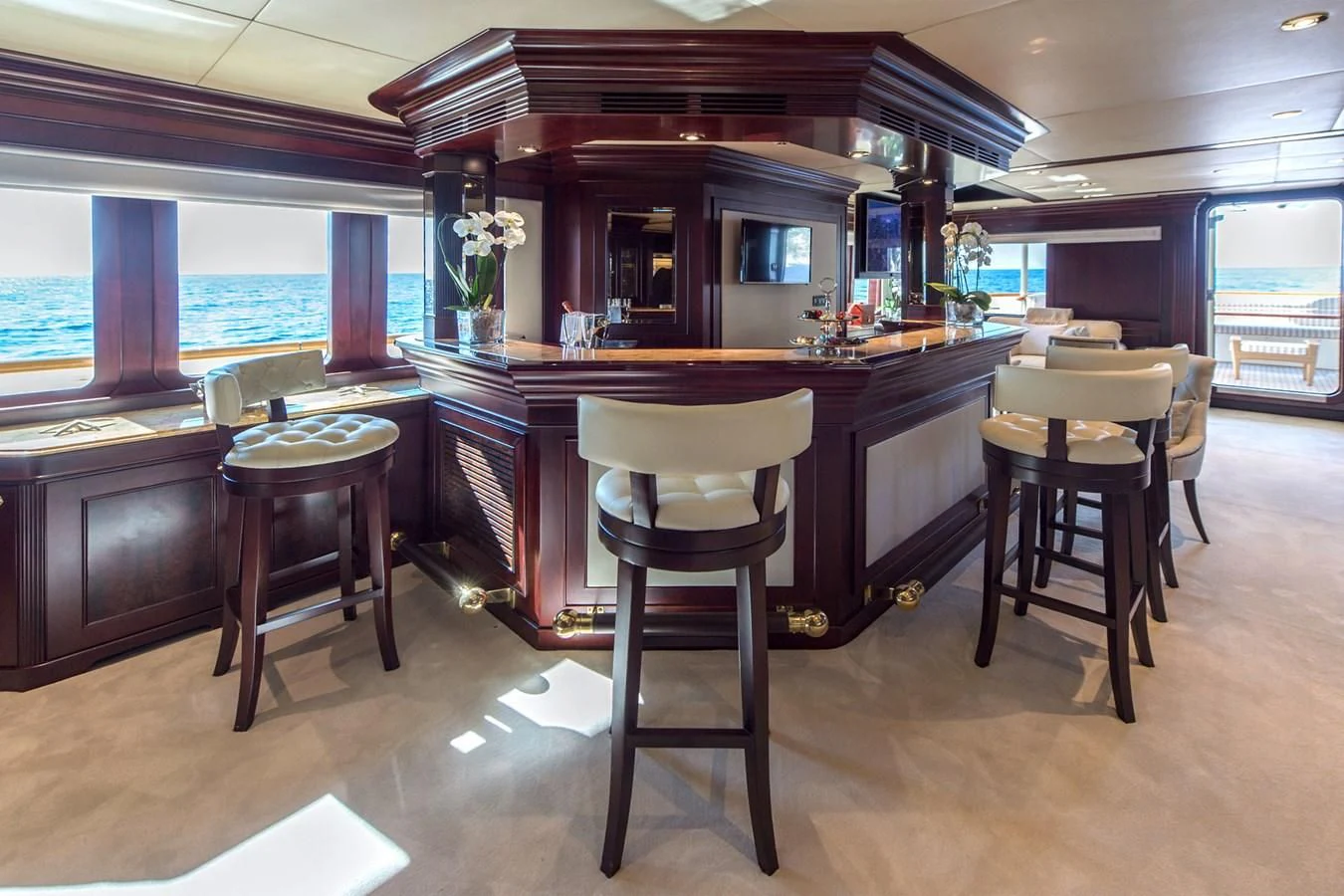 a kitchen with stools and stools aboard LIBERTA Yacht for Sale