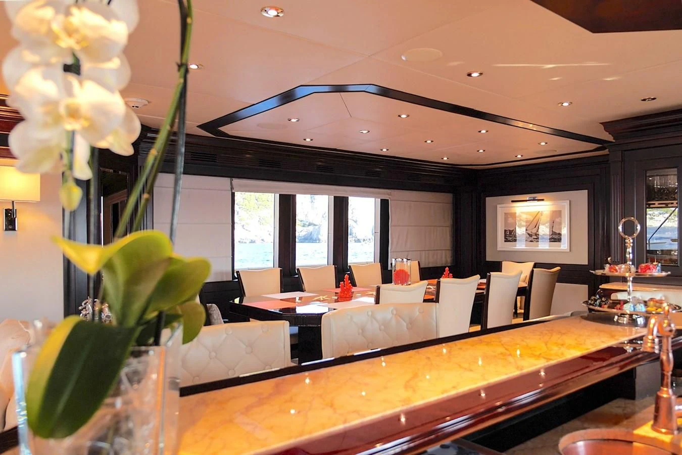 a room with a large table and chairs and a large window aboard LIBERTA Yacht for Sale
