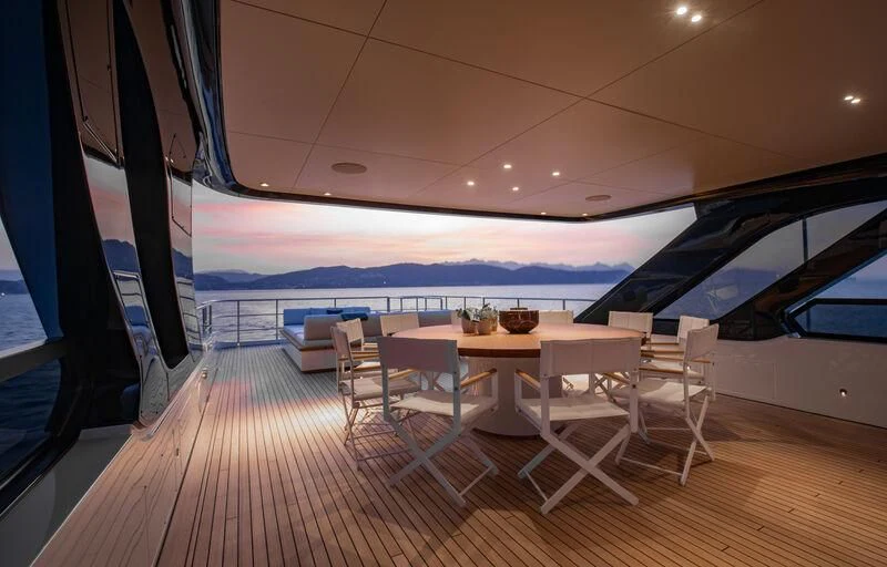 a room with a table and chairs aboard LEGEND Yacht for Sale