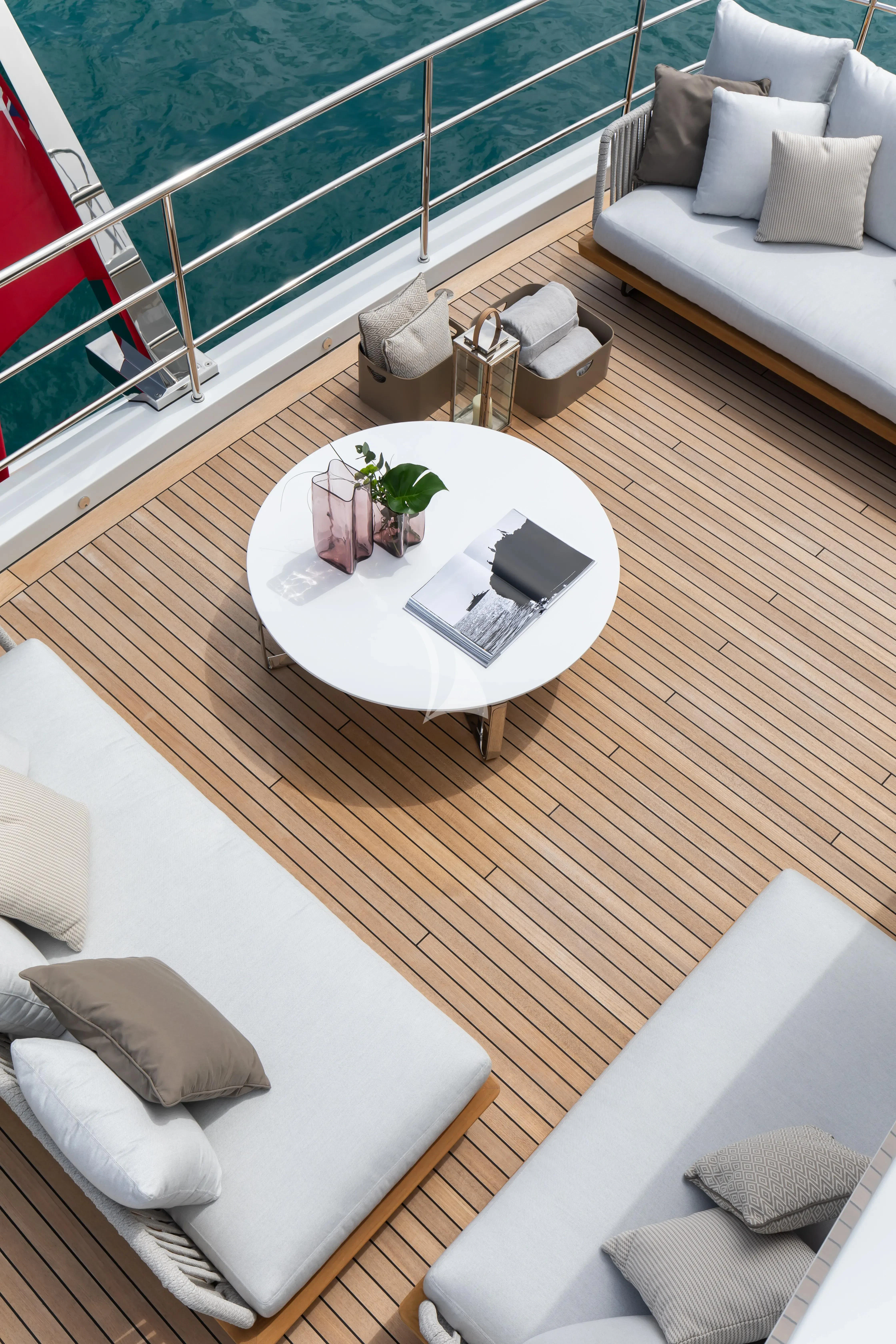 a room with a table and couch aboard LEGEND Yacht for Sale