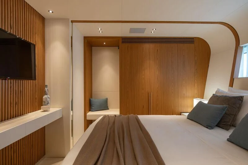 a bed with a white sheet and pillows aboard LEGEND Yacht for Sale