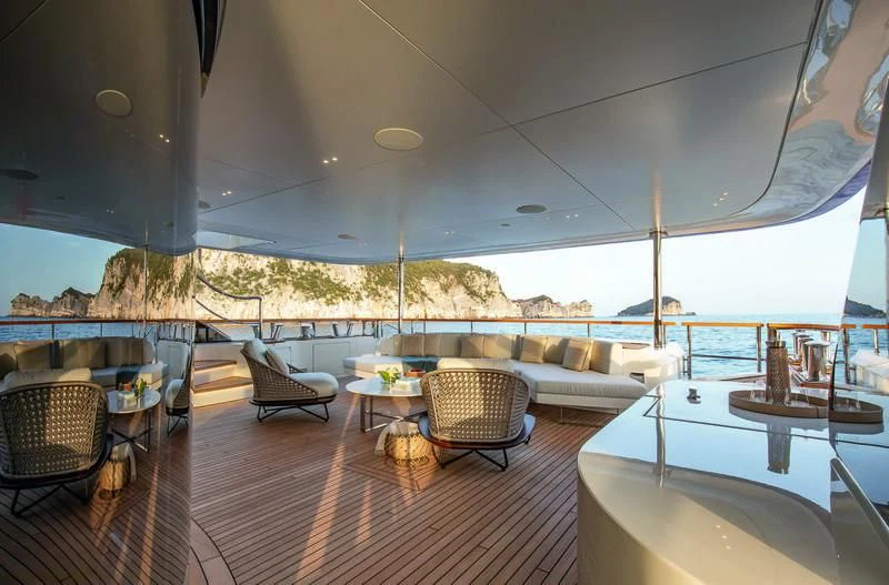 a room with a couch and a table and chairs aboard LEGEND Yacht for Sale