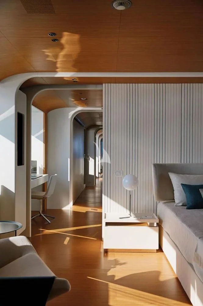 a room with a bed and a desk aboard LEGEND Yacht for Sale