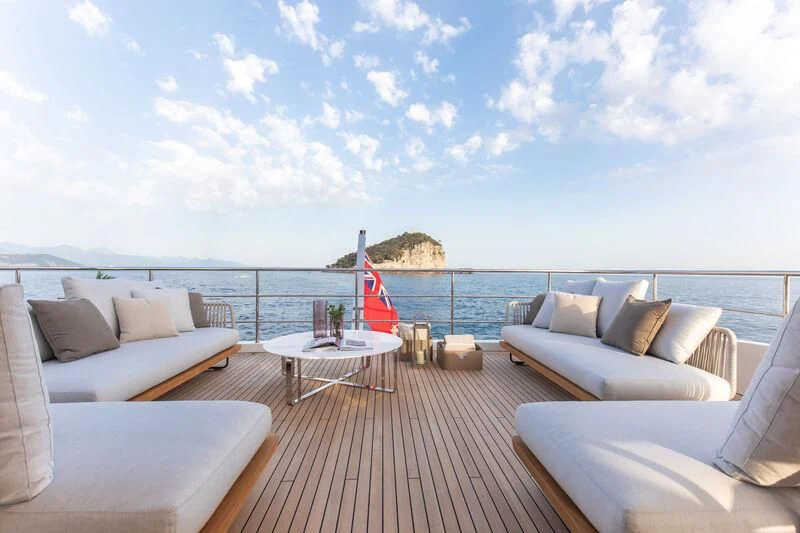 a deck with a large body of water and a beach aboard LEGEND Yacht for Sale