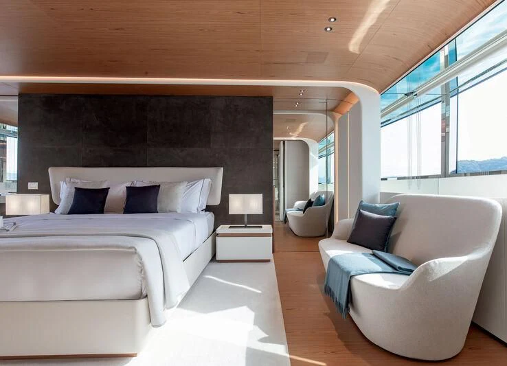 a room with a bed and a couch aboard LEGEND Yacht for Sale
