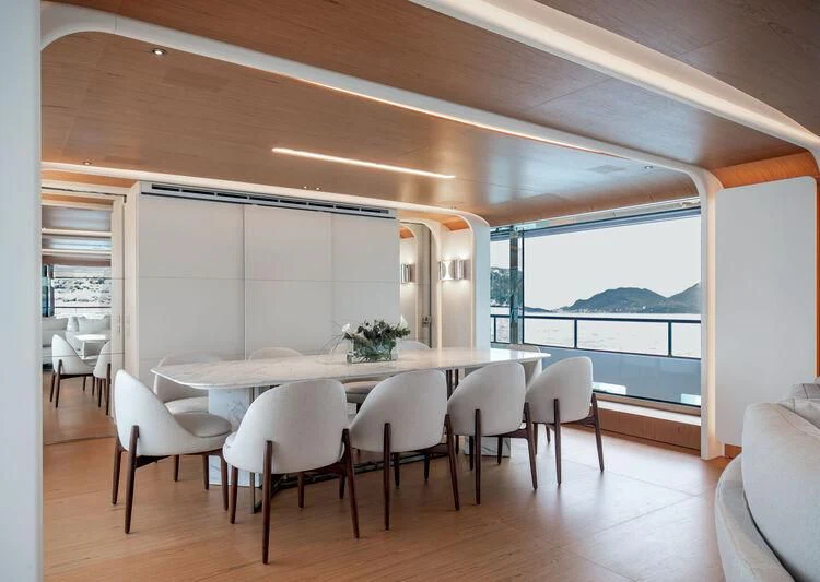 a room with a table and chairs aboard LEGEND Yacht for Sale