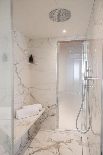 a bathroom with a glass shower aboard LEGEND Yacht for Sale