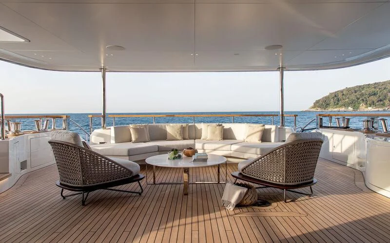 a living room with a couch and a table aboard LEGEND Yacht for Sale