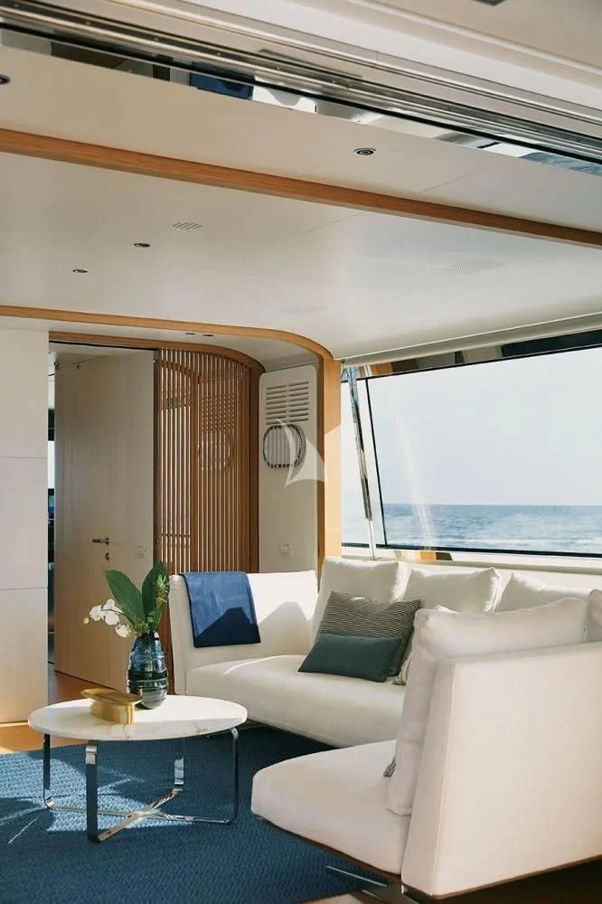 a room with a couch and a table aboard LEGEND Yacht for Sale